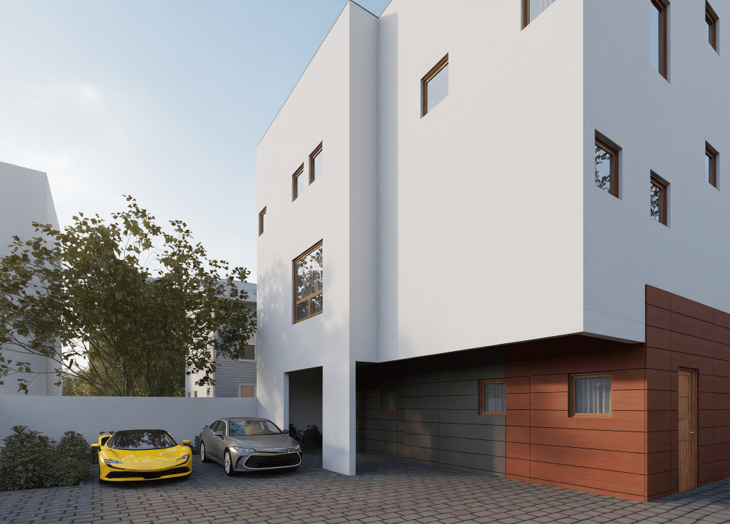 Contemporary white and wood-paneled building exterior, paved driveway, with two cars parked in the foreground.